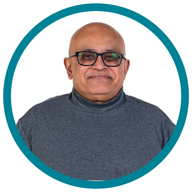 A person with glasses smiling.